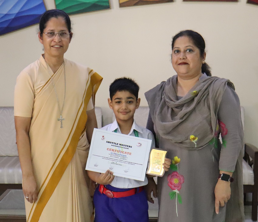 A CERTIFICATE AND A TROPHY AT UNDER-9 1ST JUNIOR SINGLES BADMINTON TOURNAMENT